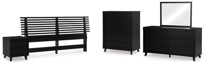 Danziar King Panel Headboard with Mirrored Dresser, Chest and Nightstand in Black - PKG016014