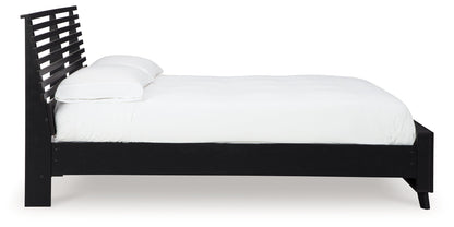 Danziar Queen Panel Bed with Mirrored Dresser and Nightstand in Black - PKG015898