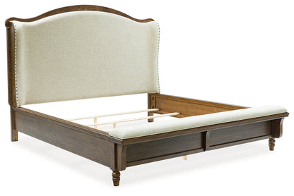 Sturlayne King Upholstered Panel Bed with Mirrored Dresser, Chest and 2 Nightstands in Brown from Ashley - Luna Furniture