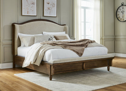 Sturlayne King Upholstered Panel Bed with Mirrored Dresser, Chest and 2 Nightstands in Brown from Ashley - Luna Furniture